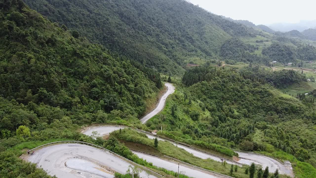 山间公路鸟瞰图，穿过森林景观，从高山口蜿蜒的道路。山上弯弯曲曲的小路视频素材