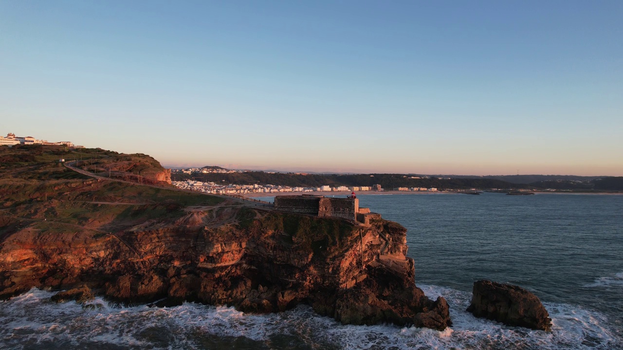 Aerial footage of the classic cliff in front of the sea in Nazaré Portugal视频素材