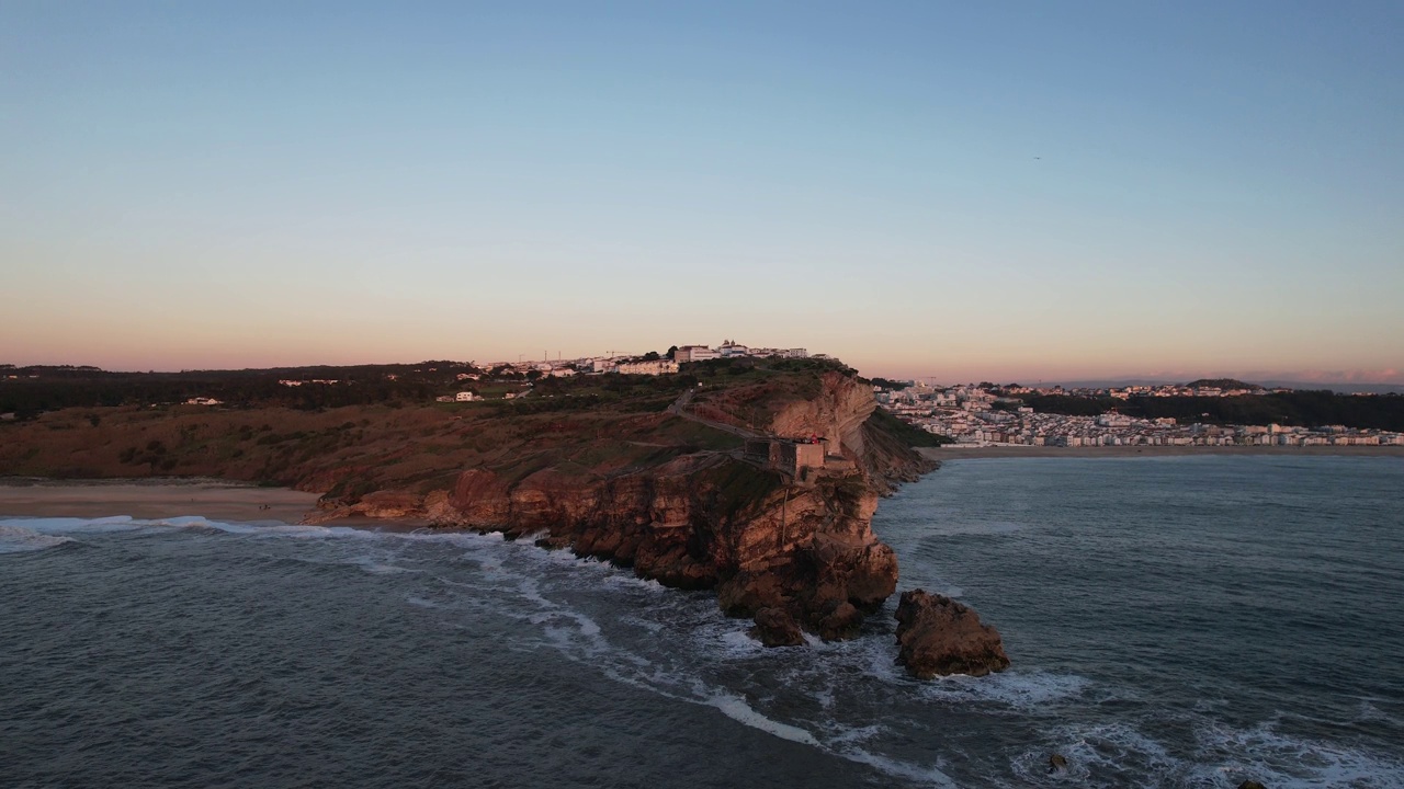 Aerial footage of the classic cliff in front of the sea in Nazaré Portugal视频素材