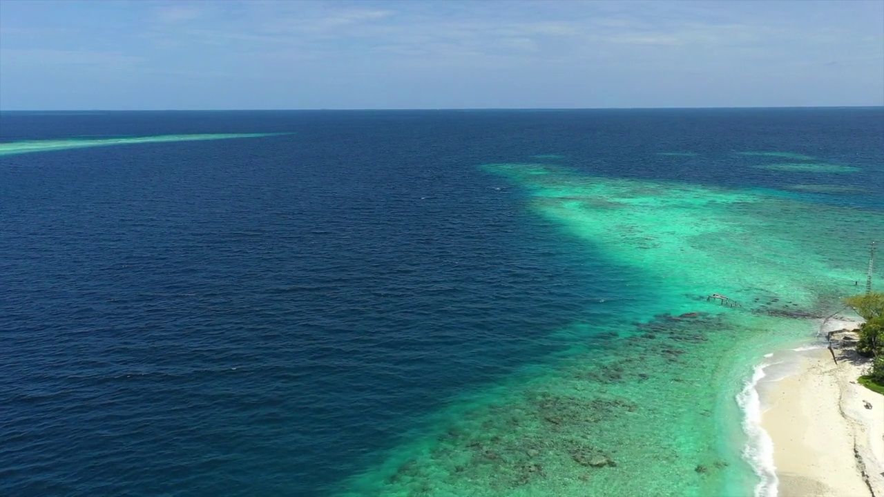 在阳光灿烂的日子里，空中前进的海景海浪风景视图-马尔代夫的thulushoo视频素材