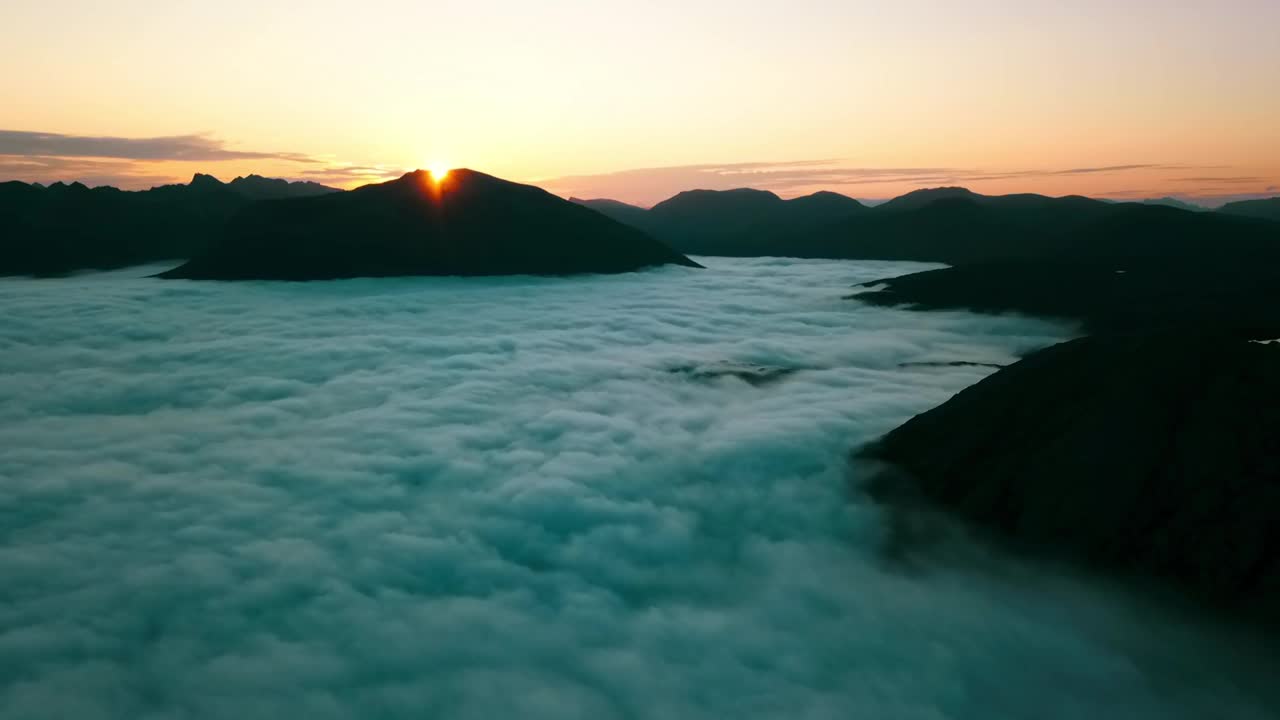 空中锁定慢动作拍摄绒毛云移动的山脉在宁静的日落-特罗姆瑟，挪威视频素材