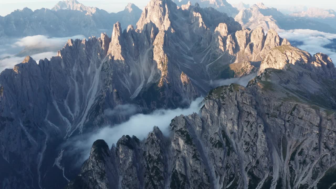 早晨阳光沐浴在白云石山脉的空中广角镜头-浓密的云层覆盖山谷视频素材