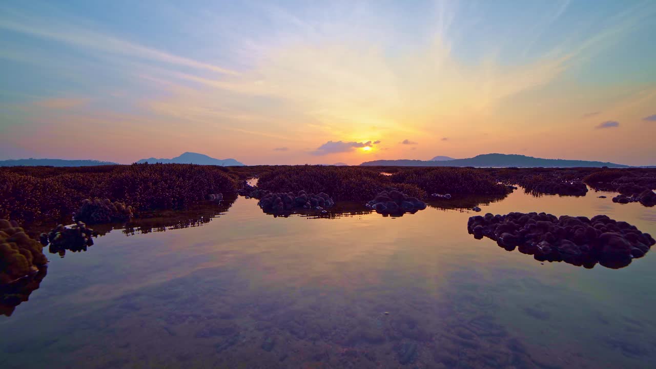 低潮时的珊瑚礁，在海上美丽的光日出在热带岛屿在泰国普吉岛令人惊叹的自然景观，令人惊叹的海景背景视频素材