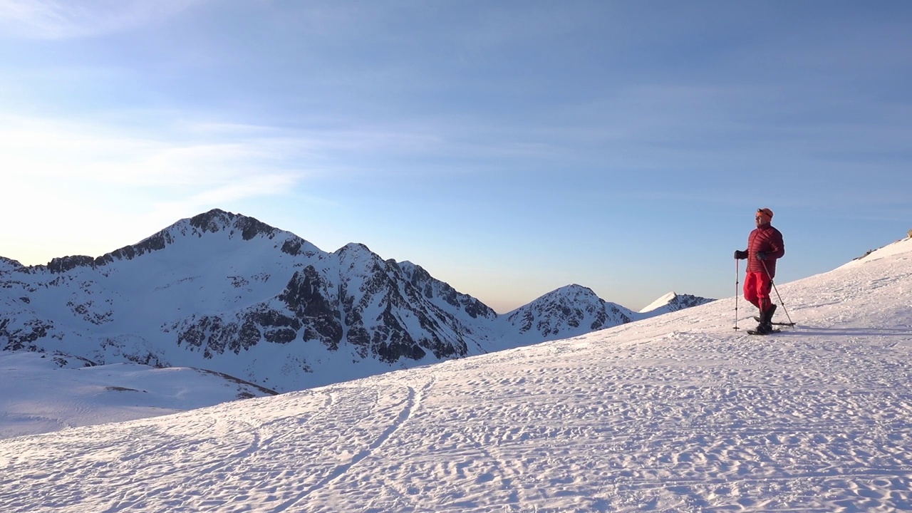 登山者沿着雪岭攀登皮林山全景视频下载