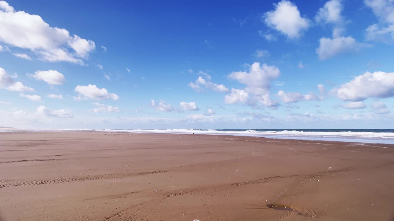 在一个阳光明媚的夏天，在退潮时走在田园诗般的海滩上视频素材