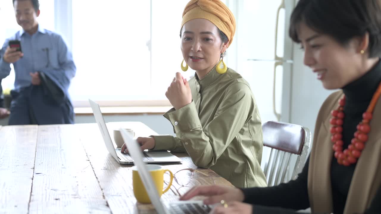 随意风格的女员工在办公室愉快地交谈视频素材