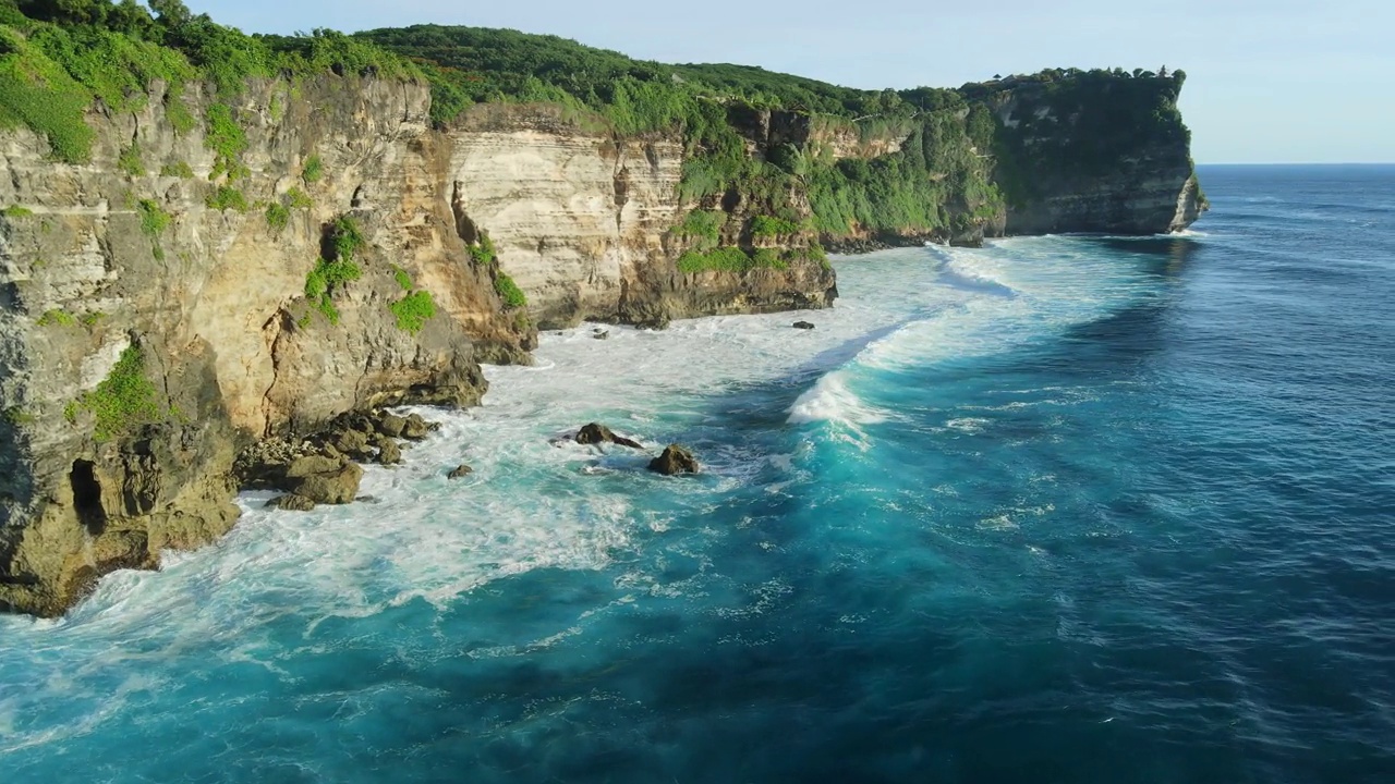 在巴厘岛的乌鲁瓦图，有悬崖、海洋和理想海浪的风景海岸线视频素材