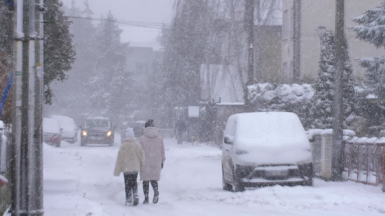 严冬暴风雪中街坊街道上的无名氏慢镜头视频素材