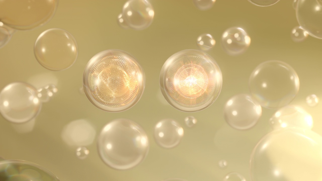 Multiple serum bubbles rise in a macro shot against a bright background.视频素材