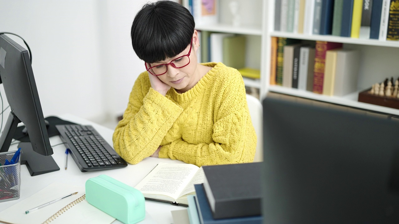 年轻的中国女学生在图书馆大学读书视频素材