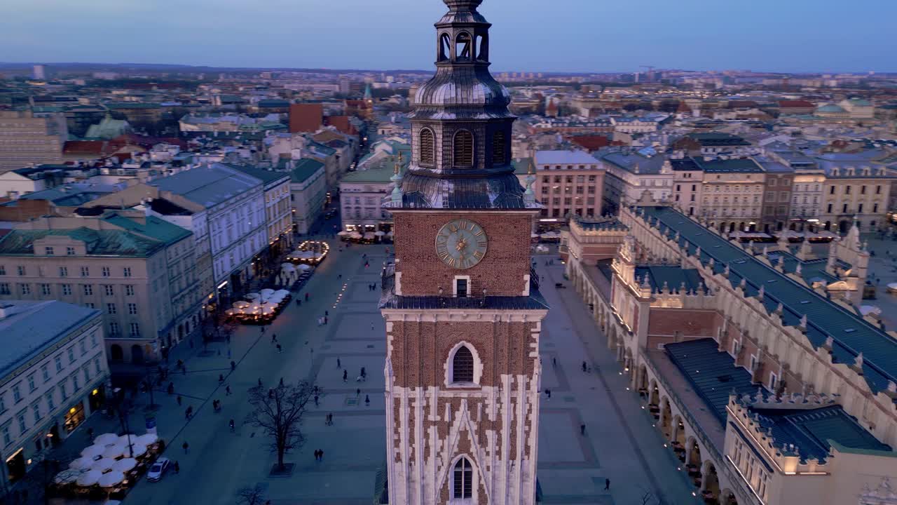 克拉科夫主要市场广场夜间无人机鸟瞰图。照明纪念碑:Mariacki(圣玛丽)教堂，Sukiennice(布厅)和市政厅塔视频素材