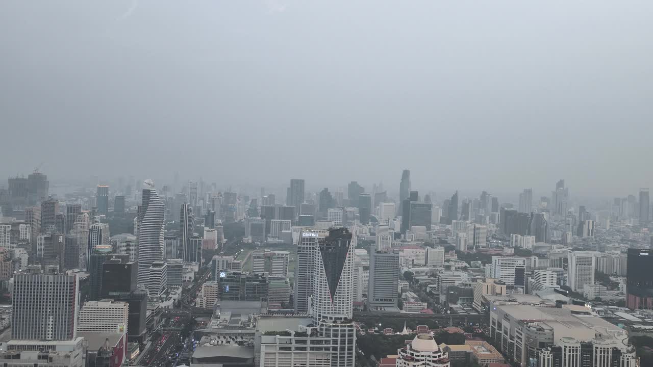 鸟瞰泰国首都曼谷高速公路上拥挤的交通，背景是密集的摩天大楼。视频素材