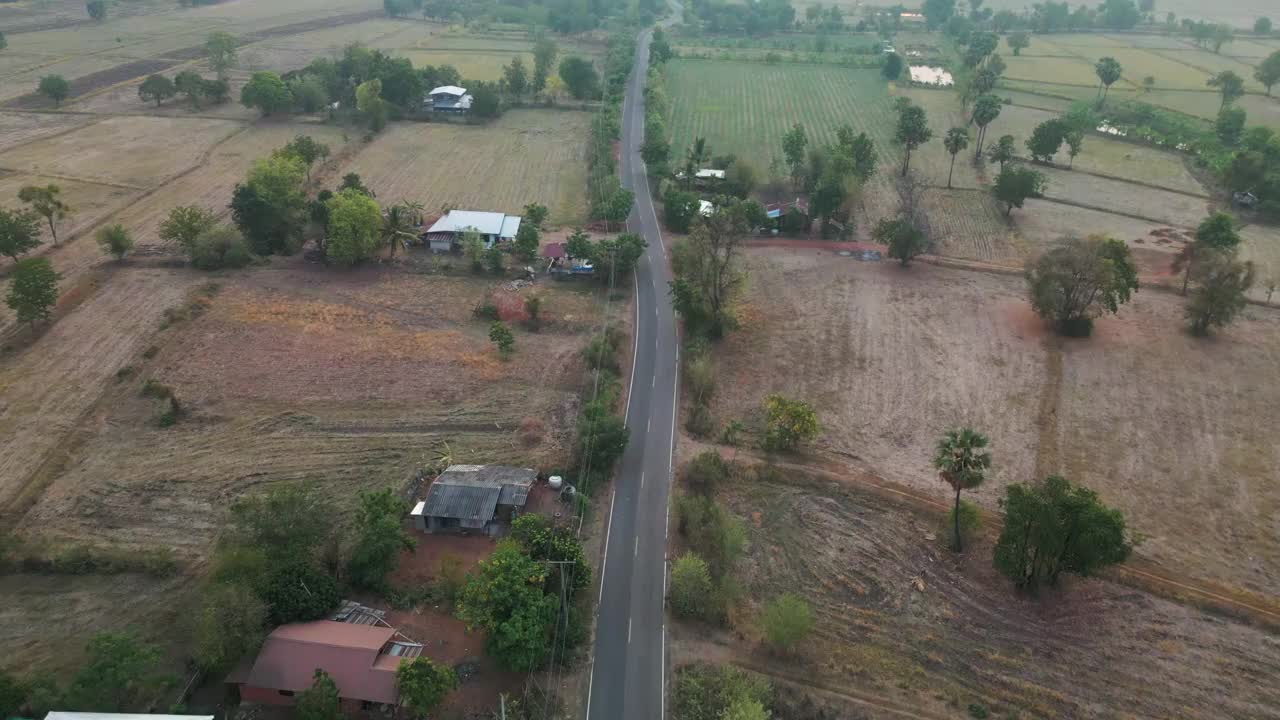 鸟瞰图与村庄和道路，田野在道路的两侧。视频下载