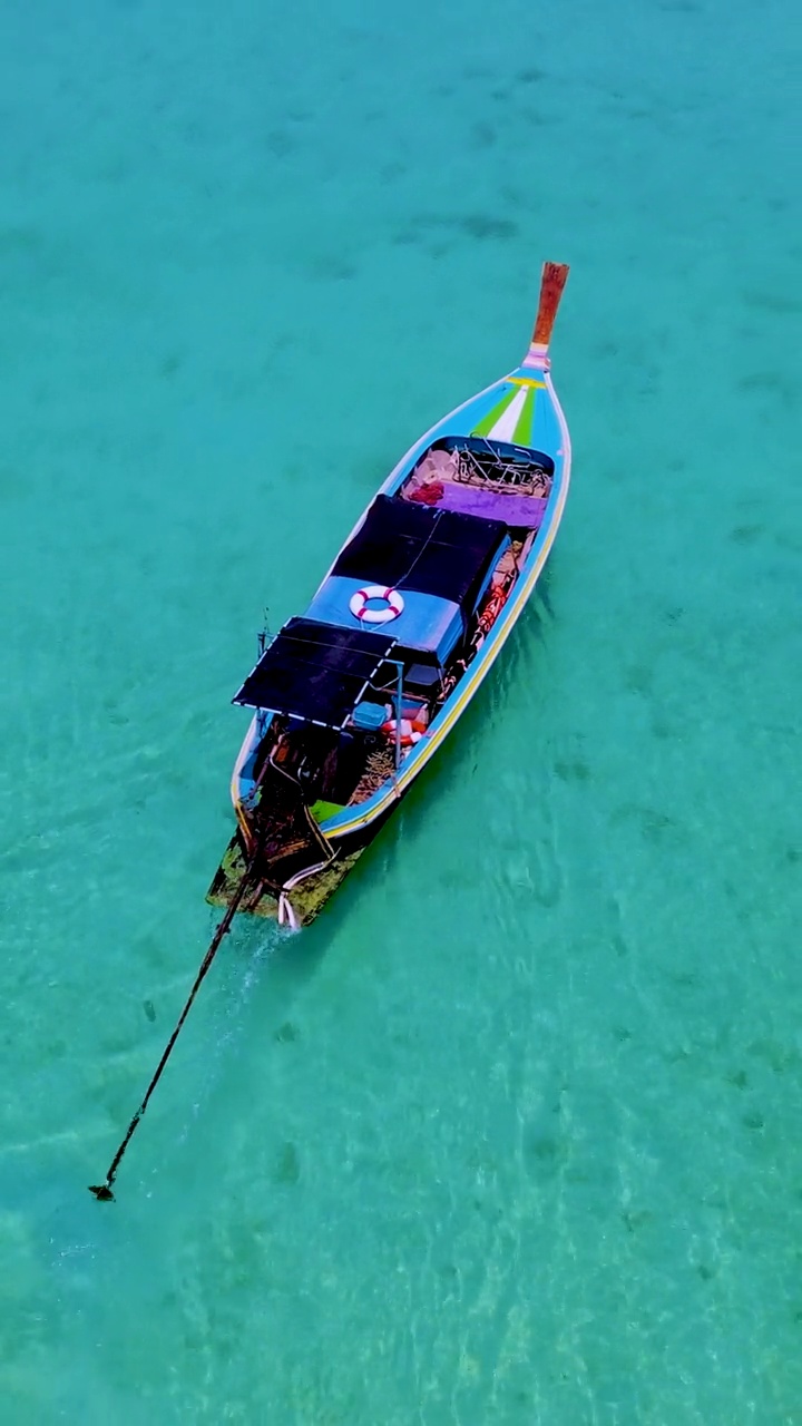 泰国南部的Koh Kradan岛，海滩上有长尾船和蓝绿色的海洋视频素材