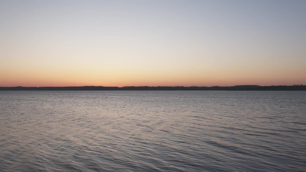 温柔的海浪和田园诗般的日落在海边视频素材