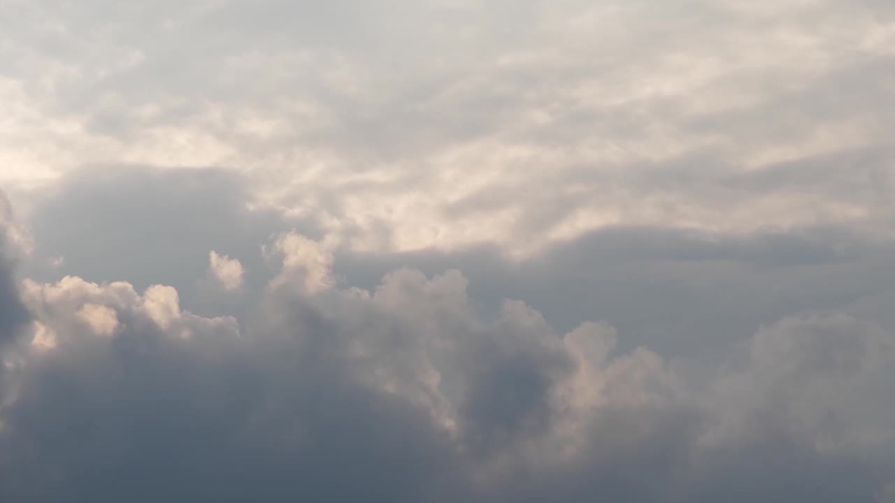 傍晚多云的天空上正常的灰云上覆盖黑色雨云的快速场景，雨季云景环境上变化的抽象美延时，可用于页面过渡视频素材