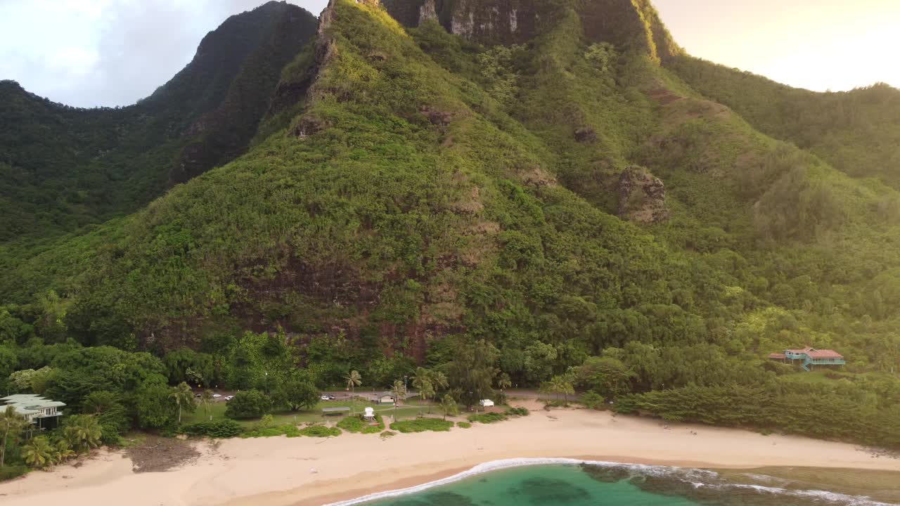 美丽的场景，沙丘隧道海滩与绿色的山丘在日落的夏威夷视频素材