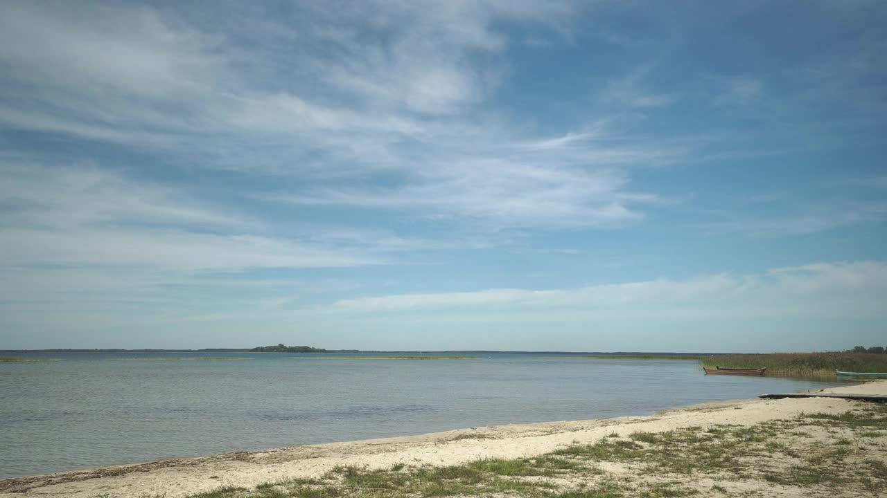 美丽的风景与海岸，海滩，钓鱼木船和岛屿在一个阳光明媚的日子，乌克兰的斯维提亚兹湖。视频素材