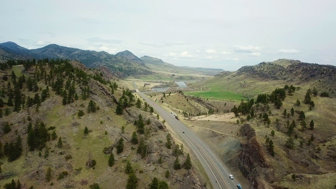 空中拍摄的道路通过山脉对天空-比林斯，蒙大拿州视频素材