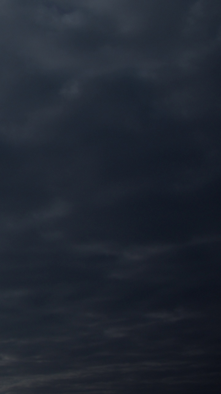 暴风雨的雨，蓬松的云。黑暗的天空。自然风景抽象背景。天气改变了背景。天空中乌云密布。垂直视频。视频素材