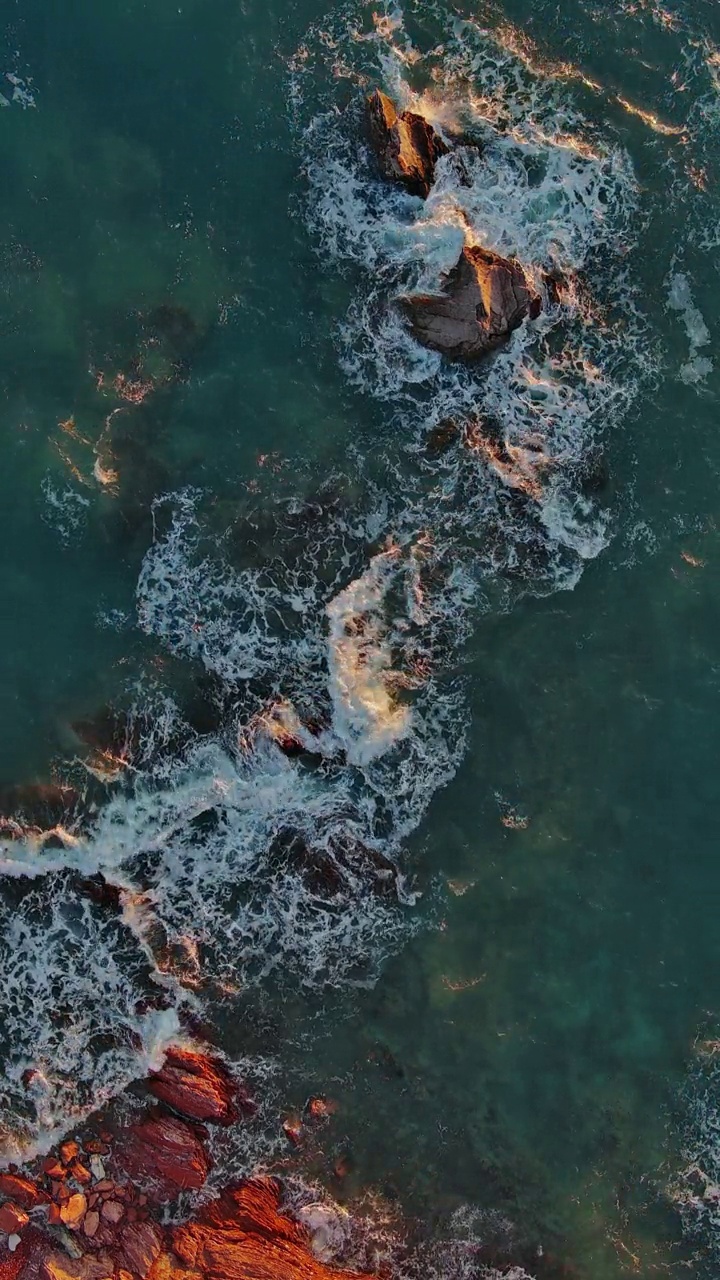 海中波浪和红色岩石的俯视图视频素材