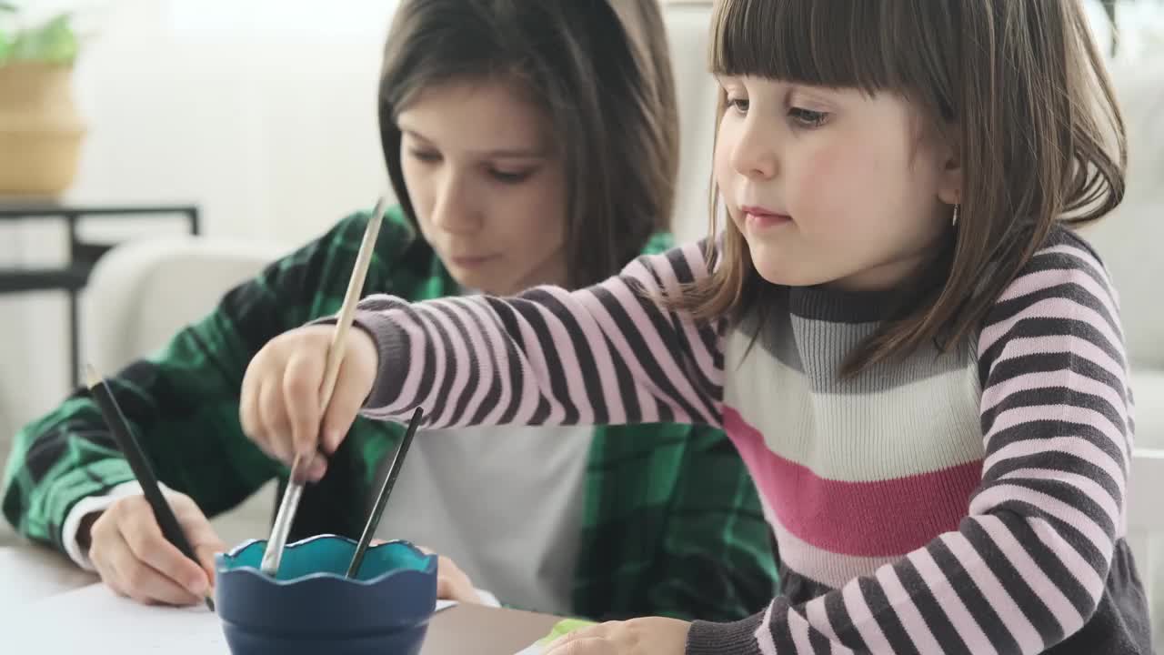 Brother and Sister Immersed in Drawing and Painting视频素材