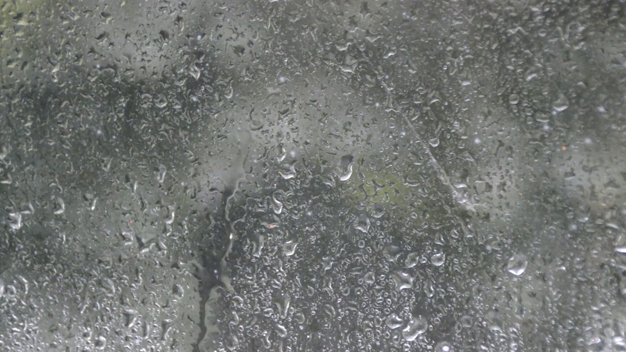 大雨从玻璃上滴落下来视频素材