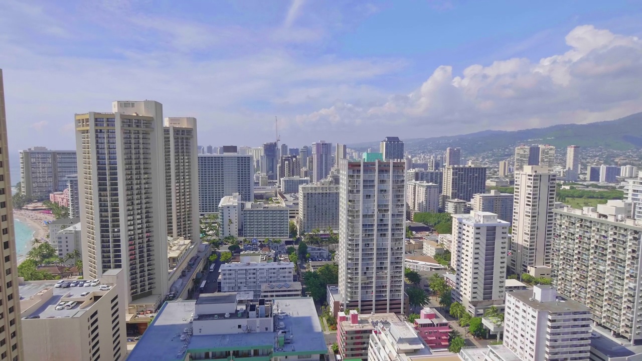 一名女子走到阳台上，欣赏着夏威夷檀香山市的美丽景色，画面为4k慢动作，每秒60帧视频素材