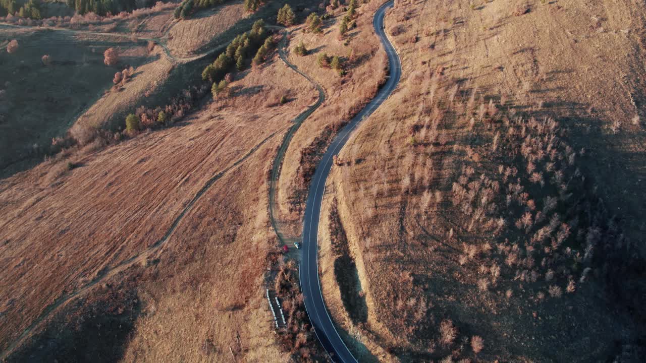 令人惊叹的秋季旅行场景，弯曲的道路通往山脉的山峰，航拍视频素材