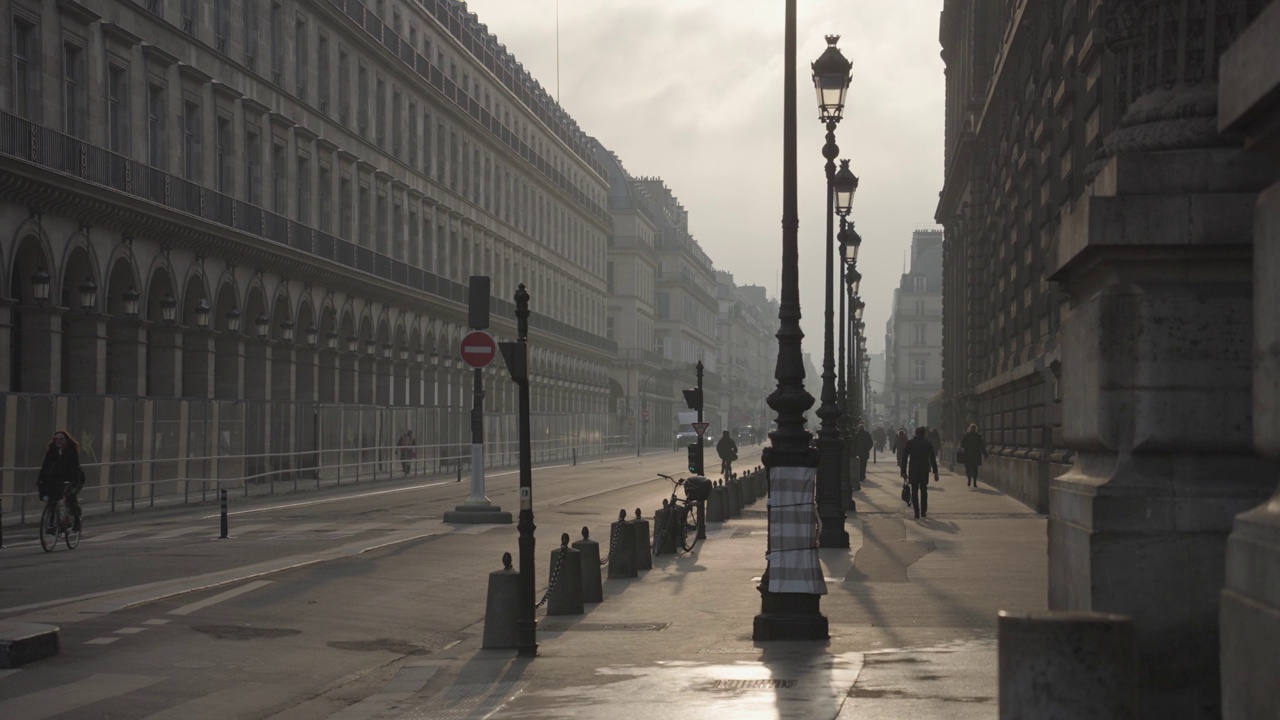 巴黎，法国——人们通勤，汽车，自行车在Rue De Rivoli街早晨温暖的日出视频素材