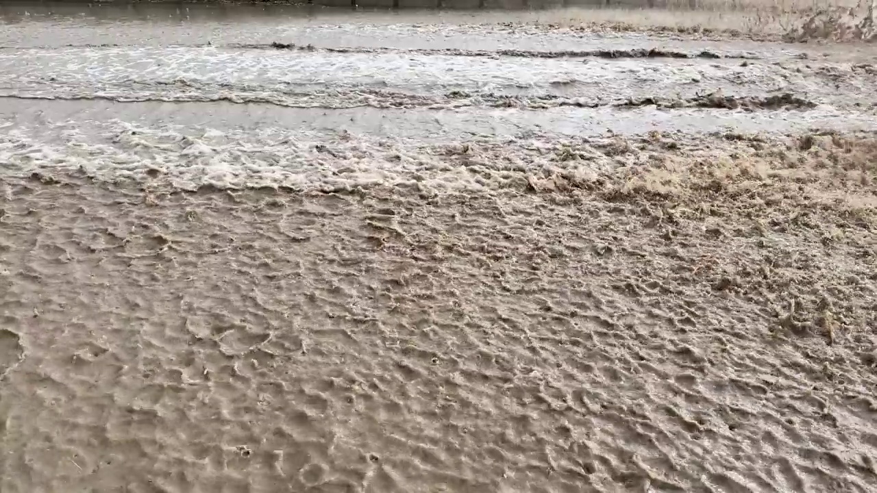 汽车在雨中驶过，轮胎把水溅到空中视频素材