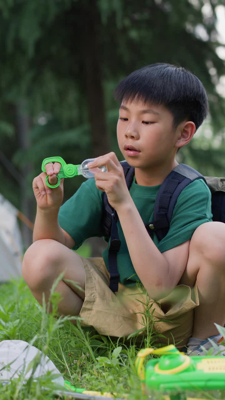 亚洲男孩在露营时抓昆虫视频素材