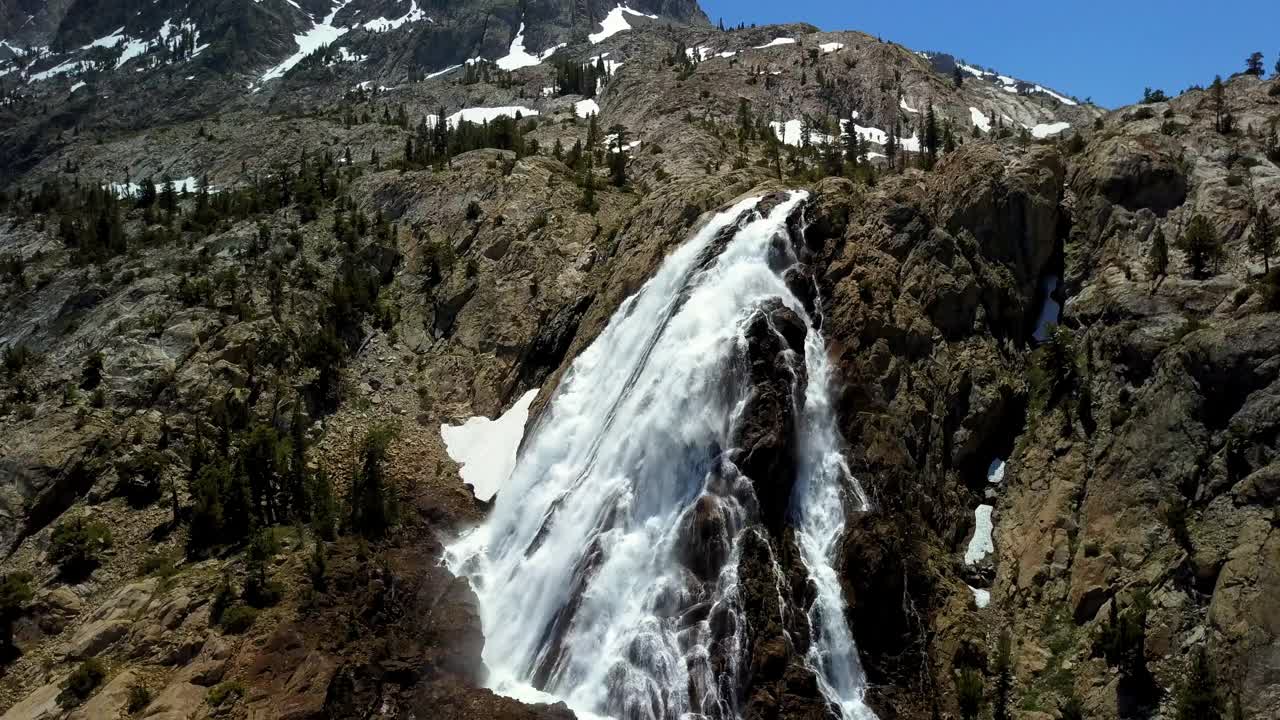 空中倾斜的瀑布在山上与冰川对着天空，无人机飞越自然景观-猛犸湖，加利福尼亚视频素材