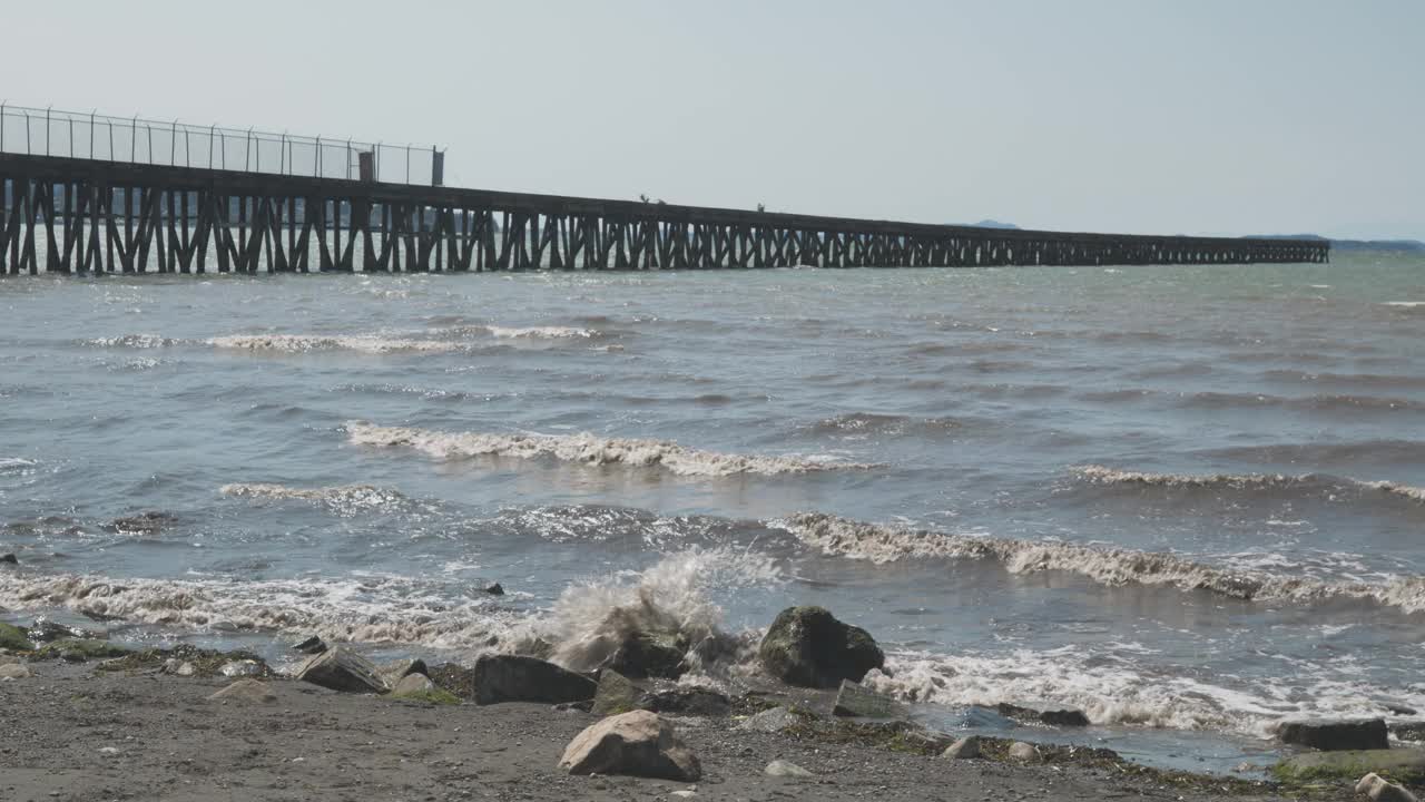 海浪拍打在华盛顿州贝灵汉湾Squalicum海滩的岩石岸边视频素材