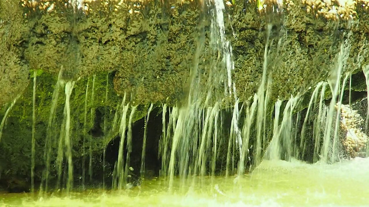 水滴穿过瀑布的岩石，特写。视频素材