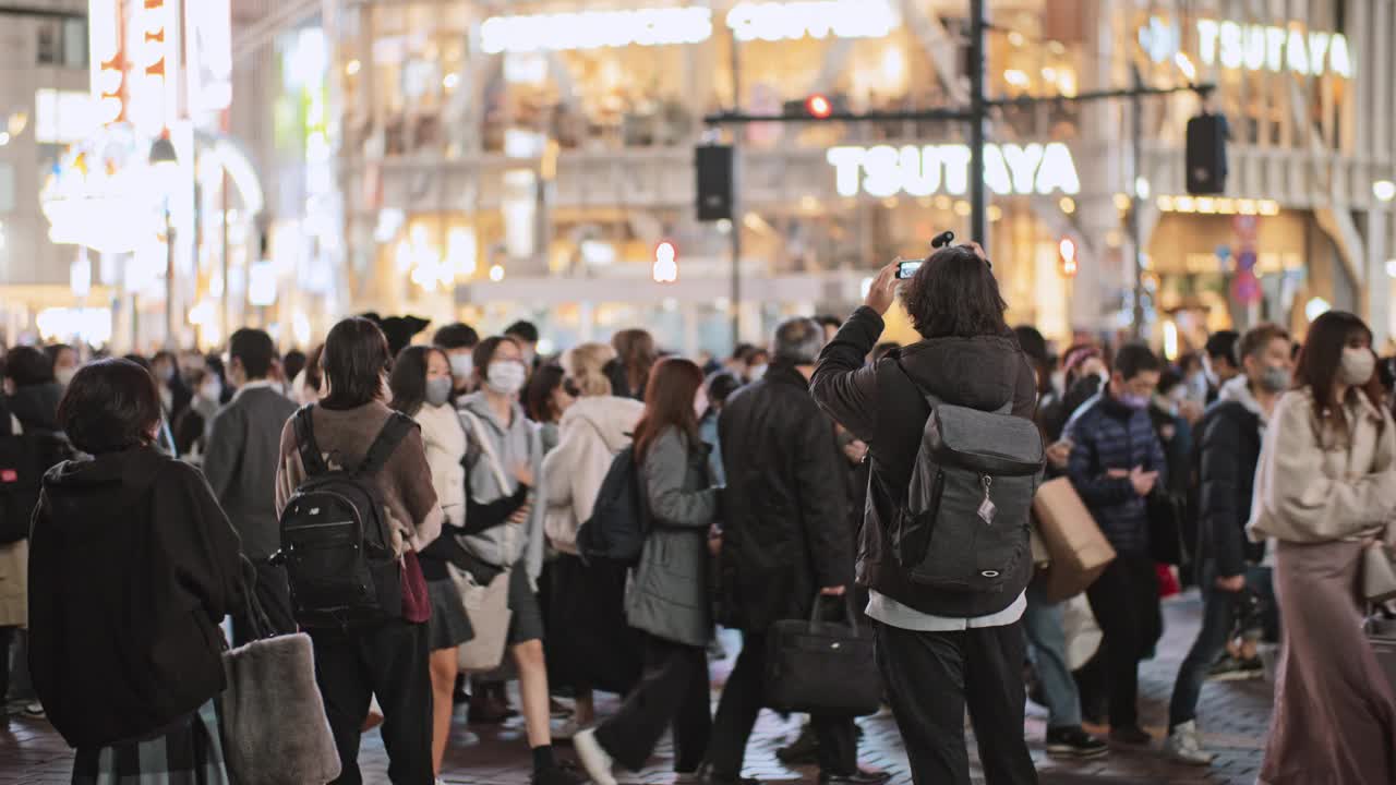 拥挤的日本人、亚洲人、游客在东京涩谷十字路口行走、汽车交通运输。日本旅游胜地，旅游地标，亚洲交通都市生活视频素材