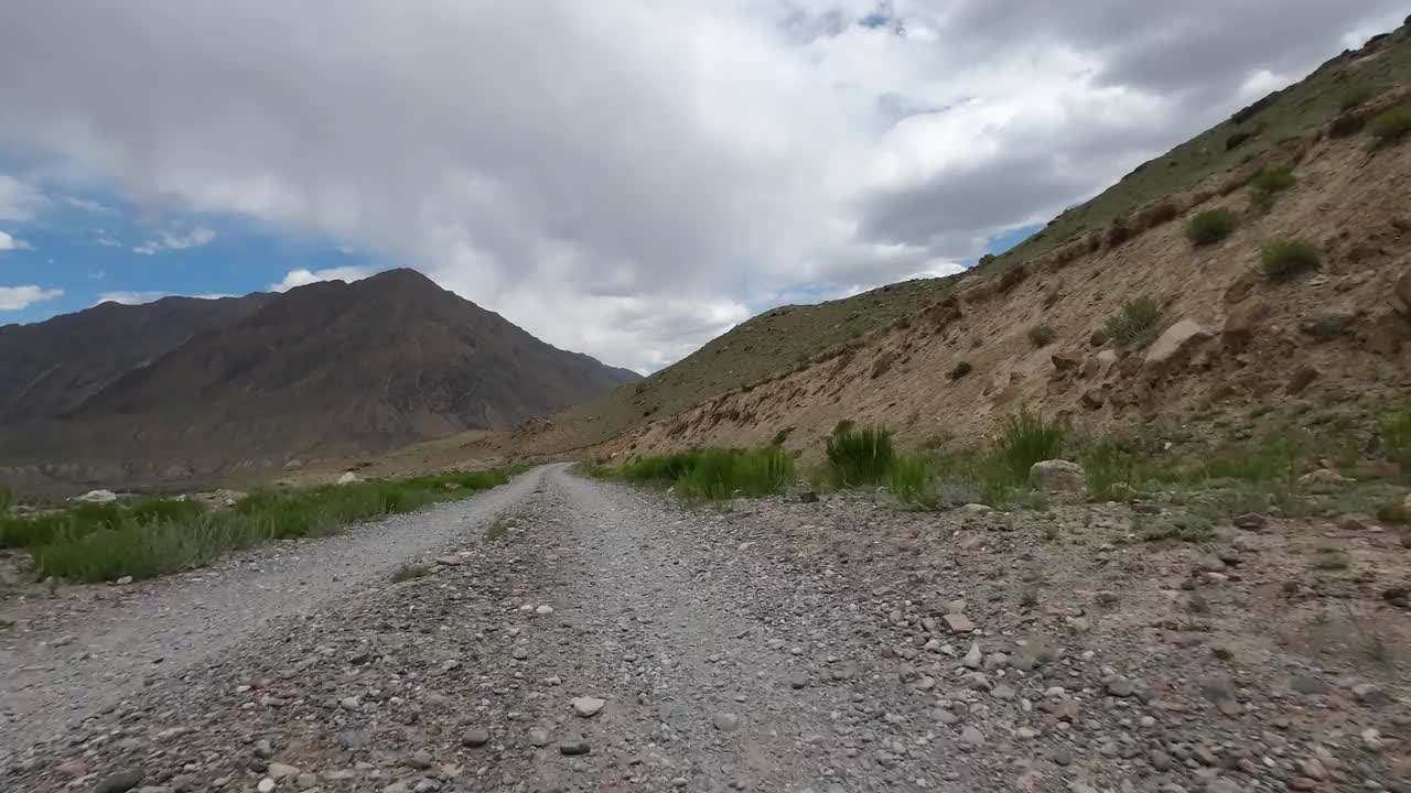 在壮观的天空下驾车行驶在山谷中。汽车的观点视频素材