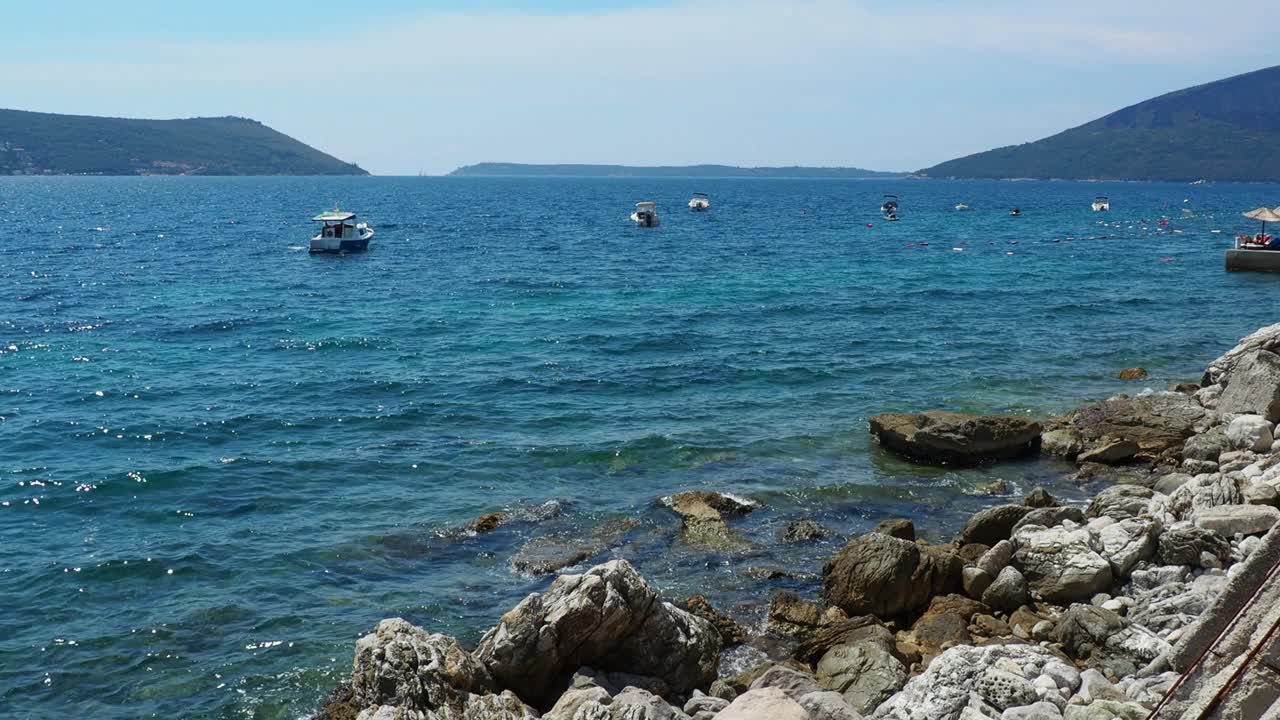 海上度假旅行。小船漂浮在亚得里亚海上。地中海旅游业务。帆船和山脉。水波纹。阳光明媚的天气。钓鱼放松。蓝绿色的波。视频素材