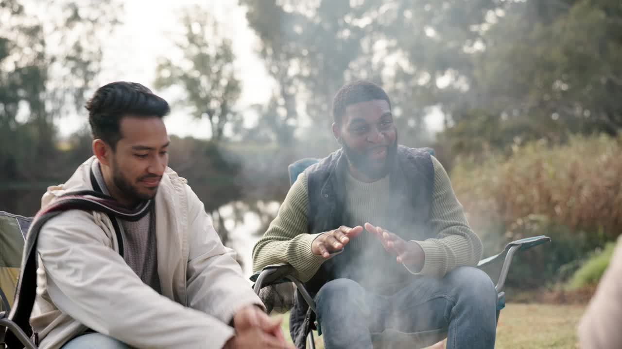 朋友，篝火和人们在大自然中谈论户外的乐趣，冒险和森林旅行。露营，男人组和有趣的故事或讨论在营地椅子度假，联系和自由视频素材