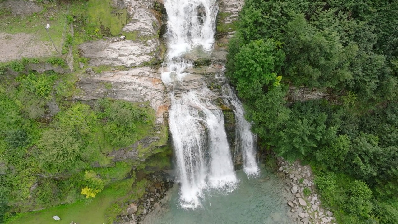 空中无人机看到的瀑布(cascata piumogna)被郁郁葱葱的绿树包围视频素材