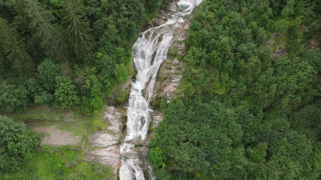 空中无人机看到的瀑布(cascata piumogna)被郁郁葱葱的绿树包围视频素材