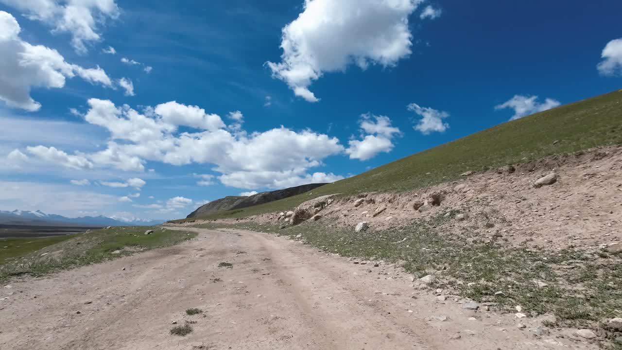 沿着山河行驶在土石路上。汽车的观点视频下载