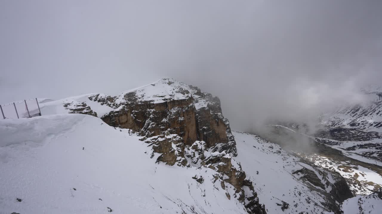 在夏天，山顶覆盖着白云和雪。视频素材