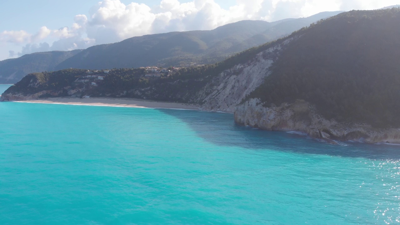 空中美丽的海滩和水湾在希腊壮观的海岸线。碧蓝透明的海水，独特的岩石悬崖，希腊夏季旅游的首选目的地莱夫卡达岛视频下载