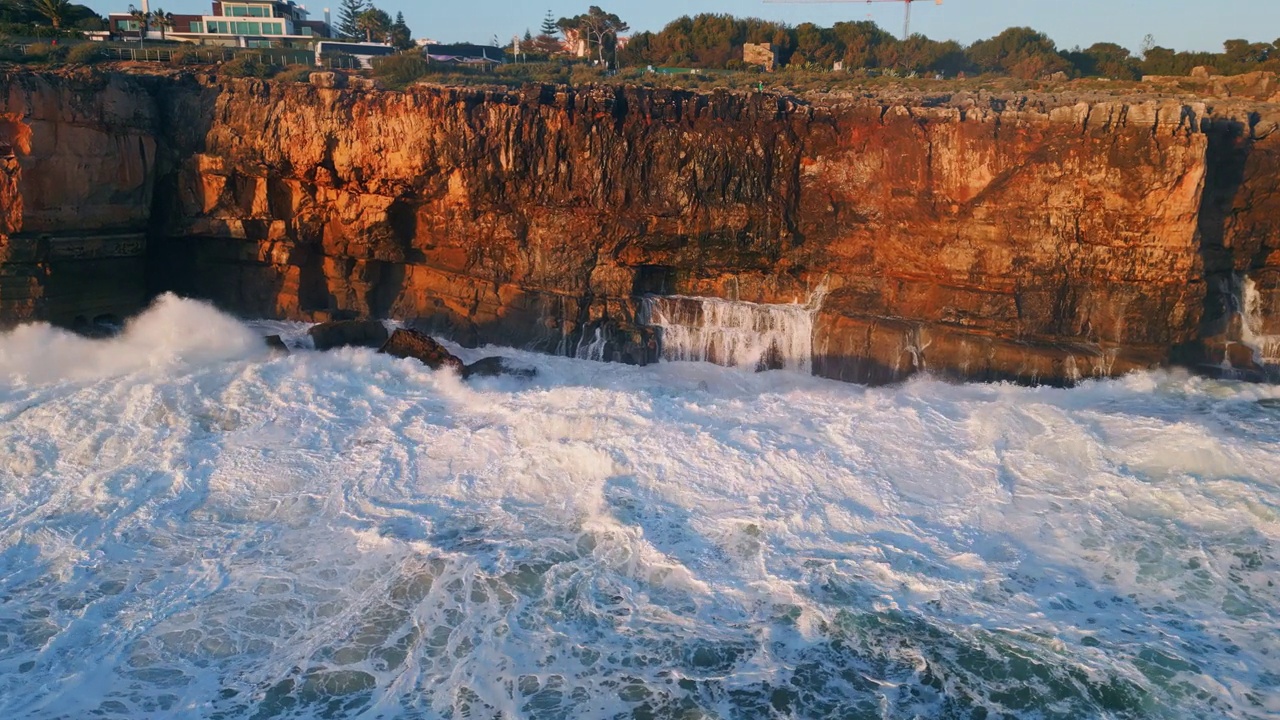 泡沫般的海水撞击危险的海岸岩石。惊涛骇浪视频素材