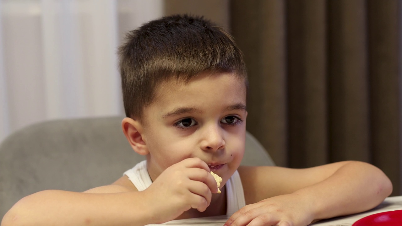 可爱的小男孩在家里吃饭视频素材