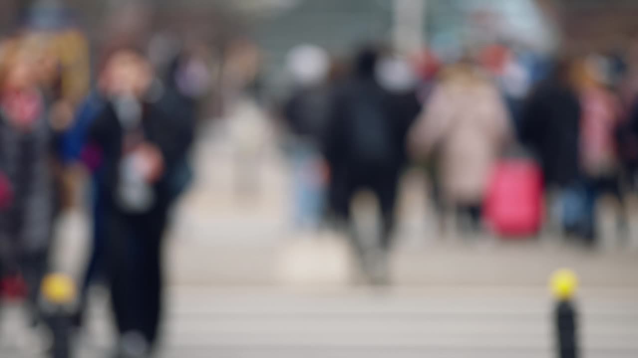 散景模糊的人拥挤步行穿过繁忙的城市街道慢动作，城市生活中，很多行人拥挤人行横道，高峰时间人行道视频素材