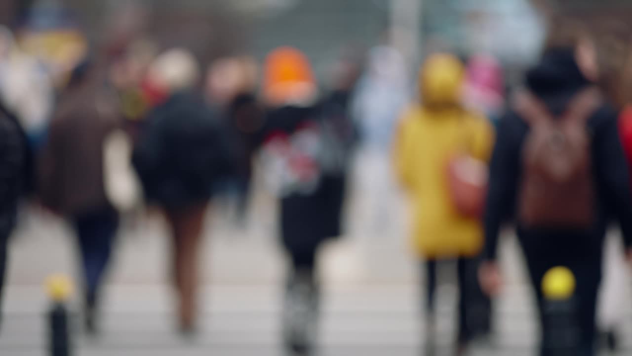 散景模糊的人拥挤步行穿过繁忙的城市街道慢动作，城市生活中，很多行人拥挤人行横道，高峰时间人行道视频素材