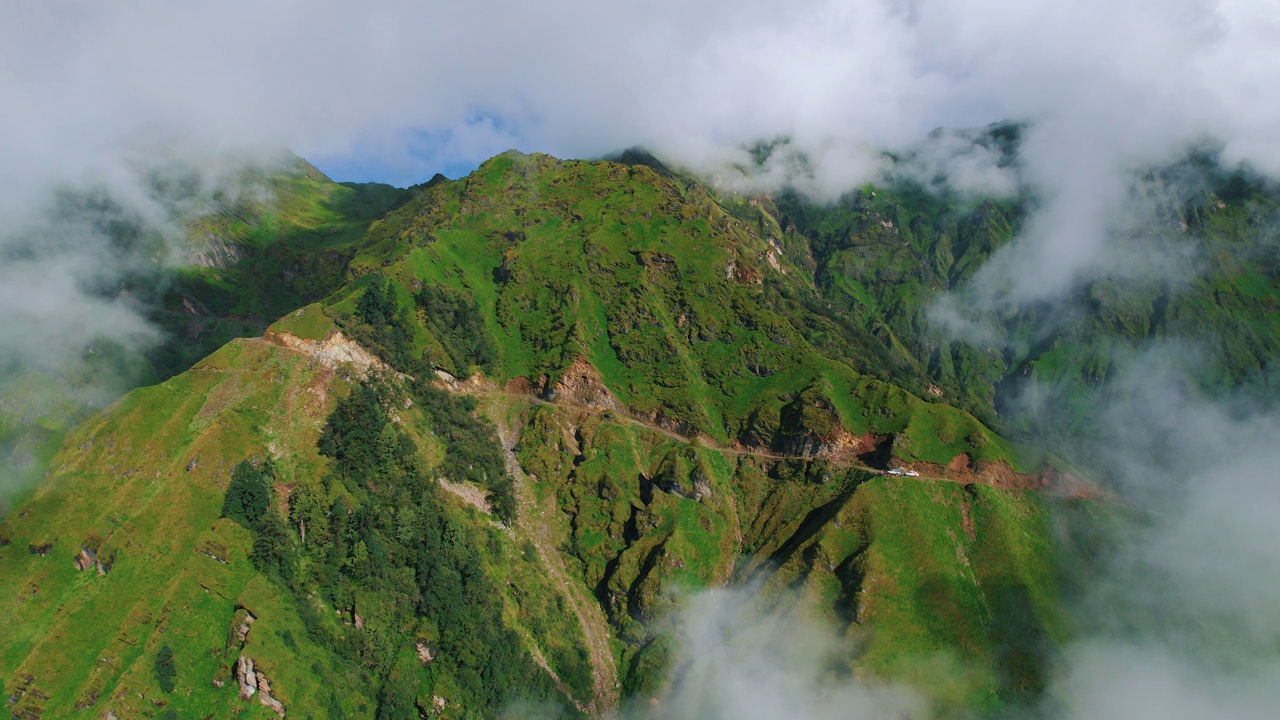 云雾覆盖绿色景观，山峦和尼泊尔徒步旅行的小径，蓝天碧绿的土地和自然清洁。极端危险和冒险的旅行体验4k视频素材