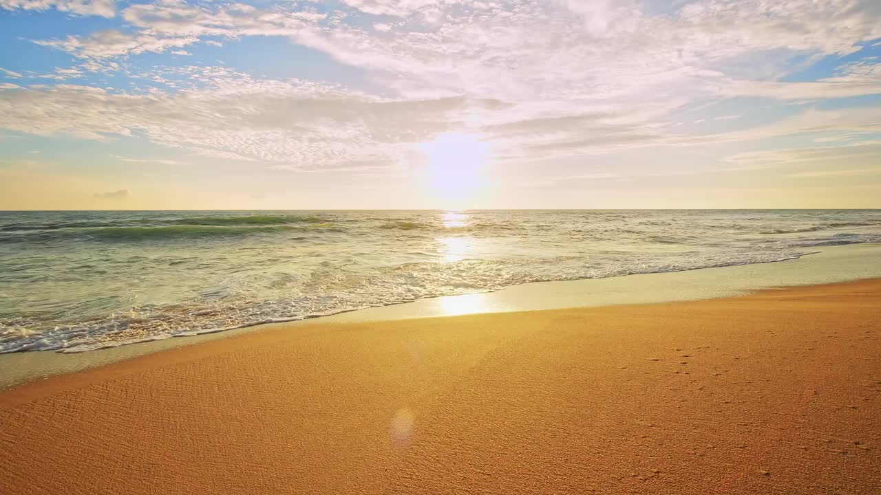 美丽的天空日落或日出在海面上美丽的海浪冲击沙滩海岸，惊人的光黄昏天空日落。电影镜头美丽的自然光海景景观背景视频素材